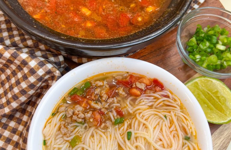 Ground pork and tomato noodle soup with rice vermicelli, tomatoes, scallions, and lime