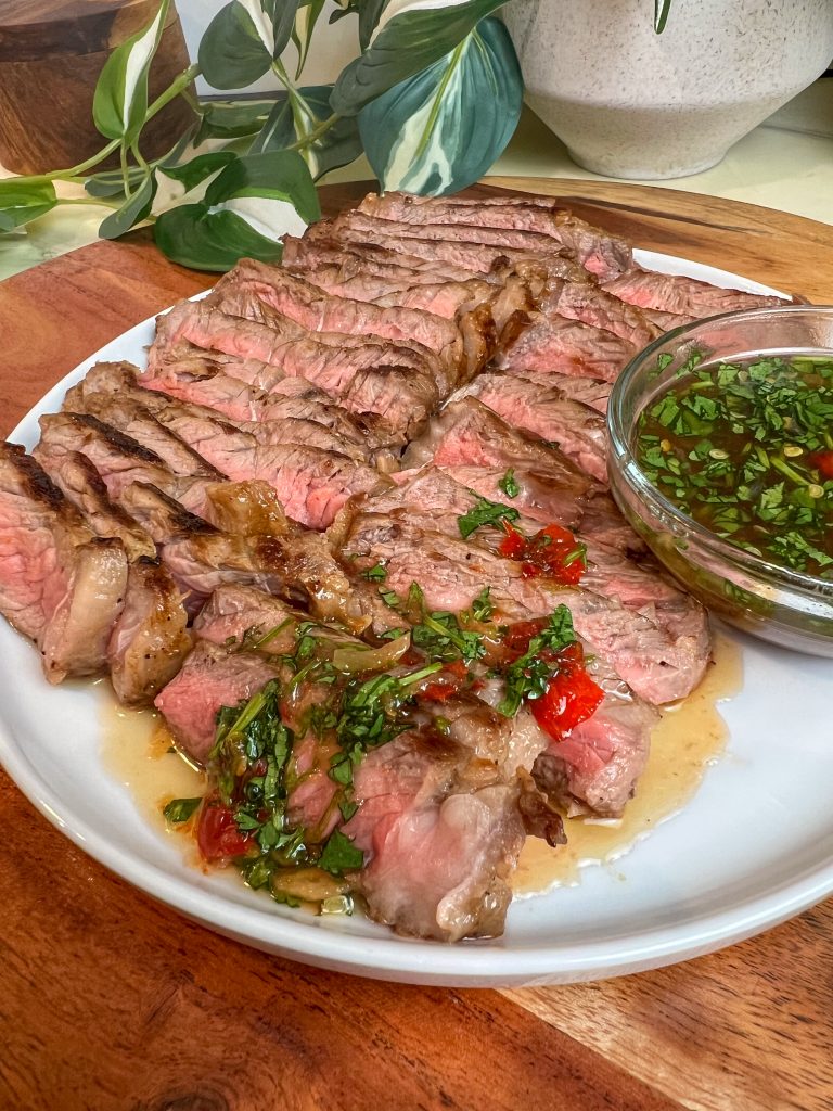 Sliced pan-seared steak with cilantro and Lao jeow som dipping sauce