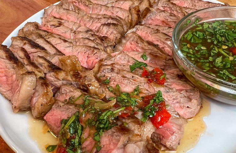 Sliced pan-seared steak with cilantro and Lao jeow som dipping sauce