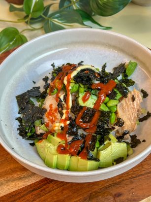 Smoked salmon rice bowl with avocado, edamame, Kewpie mayo, sriracha, and roasted seaweed.