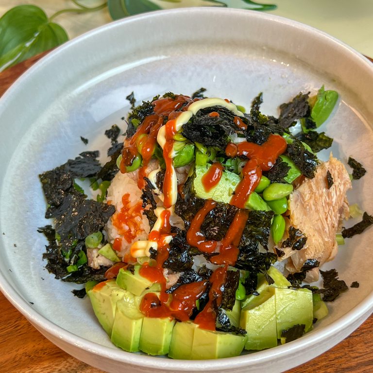 Smoked salmon rice bowl with avocado, edamame, Kewpie mayo, sriracha, and roasted seaweed.